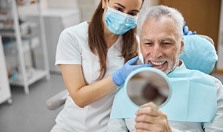 A man who just had his dental implant’s restoration attached