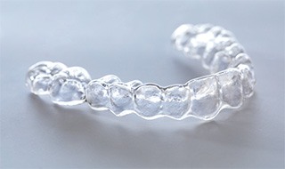 Clear aligner sitting on gray surface