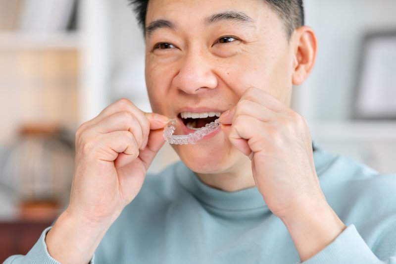 Man putting in Invisalign